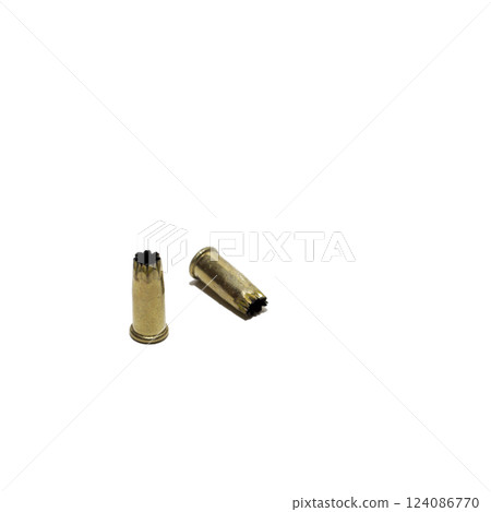gunpowder charge for powder-actuated concrete nail gun. pair of used .22-caliber blank shell. isolated on white background gunpowder charge for powder-actuated concrete nail gun. pair of used .22-caliber blank shell. isolated on white background 124086770