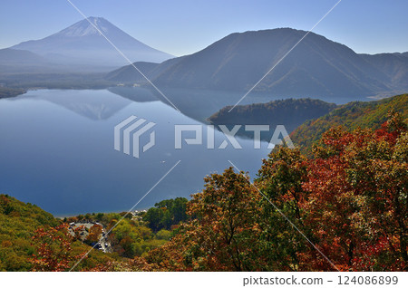 Mount Fuji as seen from Nakanokura Pass Observatory in the Tenshi Mountains, and the inverted Fuji and Ryugatake reflected in Lake Motosu with autumn foliage 124086899