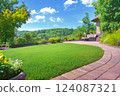 green grass lawn, plants and stone pathway in a classic courtyard 124087321
