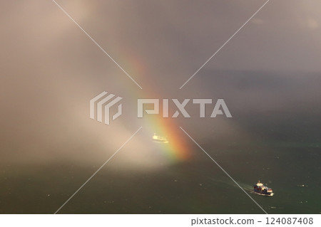 Rainbow over the sea seen from an airplane 124087408