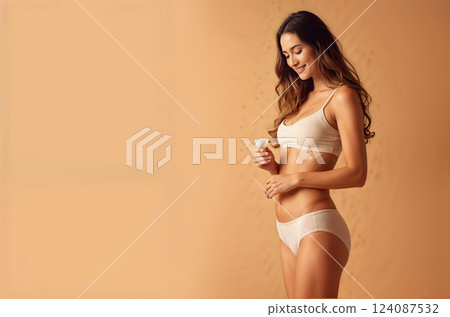 A woman is wearing a white bikini and holding a bottle 124087532