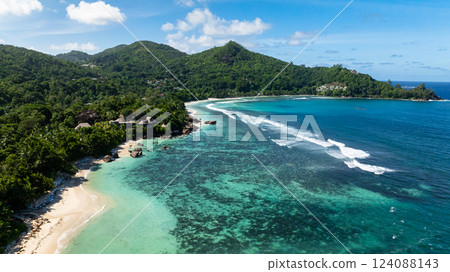 Turquoise waters meeting white sandy beaches, surrounded by green vegetation. Baie Lazare. Seychelles, Mahe. Turquoise waters meeting white sandy beaches, surrounded by green vegetation. Baie Lazare. Seychelles, Mahe. 124088143