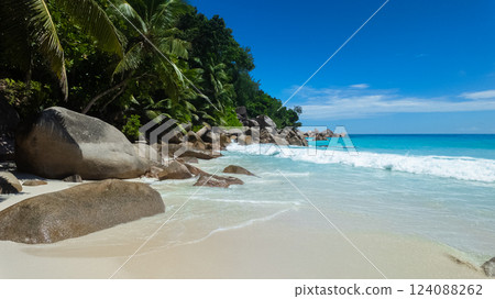 Idyllic beach with turquoise water, granite rocks, and lush tropical trees under a clear blue sky. Anse Georgette. Seychelles, Praslin. Idyllic beach with turquoise water, granite rocks, and lush tropical trees under a clear blue sky. Anse Georgette. Seychelles, Praslin. 124088262