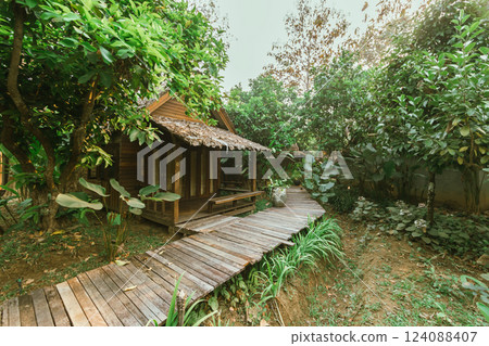 Local wooden house with tropical garden 124088407