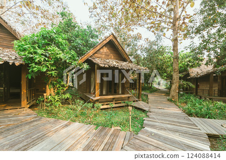 Local wooden house with tropical garden 124088414
