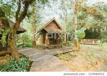 Local wooden house with tropical garden 124088432