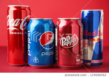 Mykolaiv, Ukraine - May 2, 2023: Cans of Coca cola, Pepsi, Dr.Pepper and Red Bull on red background. American multinational beverage company Mykolaiv, Ukraine - May 2, 2023: Cans of Coca cola, Pepsi, Dr.Pepper and Red Bull on red background. American multinational beverage company 124088562