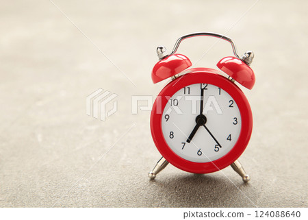 Red vintage alarm clock on grey background. Space for text Red vintage alarm clock on grey background. Space for text 124088640