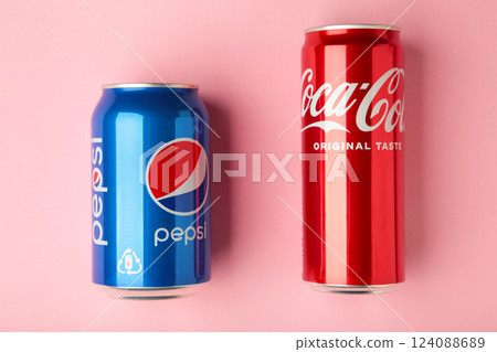 Mykolaiv, Ukraine - May 2, 2023: Coca-Cola and Pepsi cans on pink background. Mykolaiv, Ukraine - May 2, 2023: Coca-Cola and Pepsi cans on pink background. 124088689