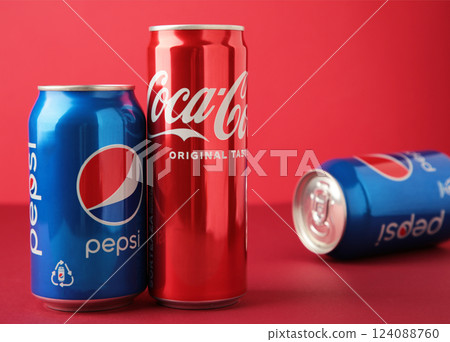 Mykolaiv, Ukraine - May 2, 2023: Coca-Cola and Pepsi cans on red background. Space for text Mykolaiv, Ukraine - May 2, 2023: Coca-Cola and Pepsi cans on red background. Space for text 124088760
