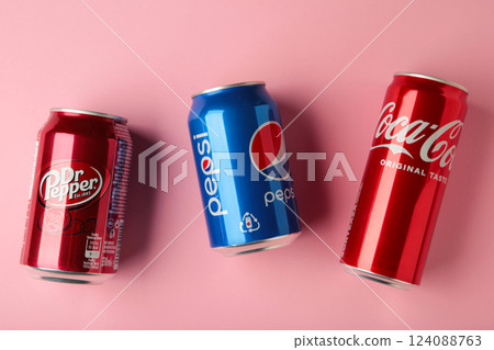 Mykolaiv, Ukraine - May 2, 2023: Cans of Coca cola, Pepsi, Dr.Pepper on pink background. American multinational beverage company 124088763