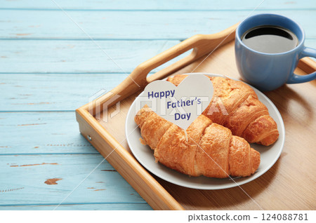 Father's day concept with gift, card and breakfast. Breakfast for dad with croissant and coffee. 124088781