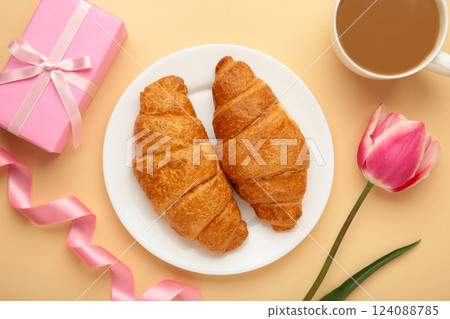 Happy mother's day, beautiful breakfast on tray, lunch with cup of coffee, fresh croissants, tulip and gift. Spring holiday, family relations. Happy mother's day, beautiful breakfast on tray, lunch with cup of coffee, fresh croissants, tulip and gift. Spring holiday, family relations. 124088785