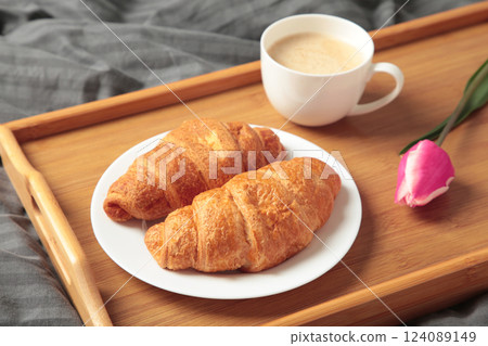 Breakfast in bed with coffee, croissants and tulip on tray 124089149