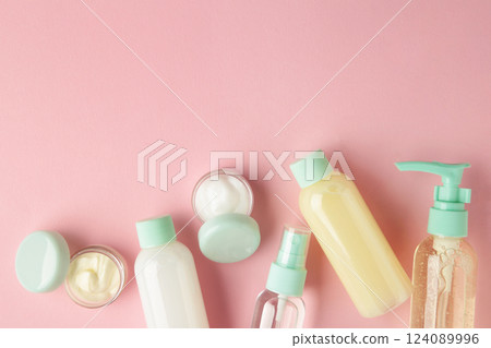Travel cosmetic bottles on pink background. Minimalist bodycare beauty products for vacation or journey. Top view. Copyspace. Travel cosmetic bottles on pink background. Minimalist bodycare beauty products for vacation or journey. Top view. Copyspace. 124089996