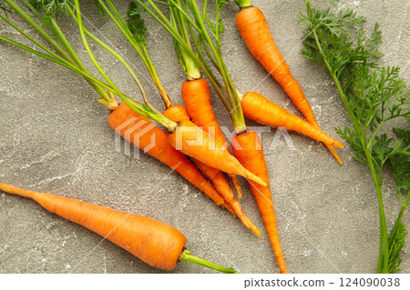 Bunch of baby carrots on grey concrete background Bunch of baby carrots on grey concrete background 124090038
