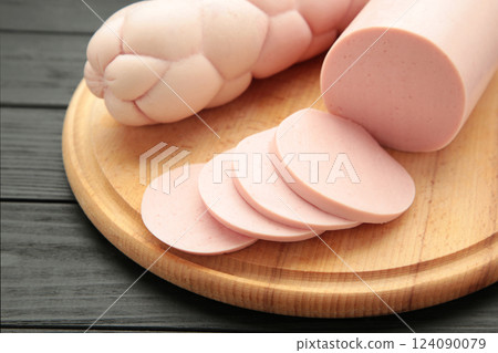 Boiled pork sausage on cutting board on black background 124090079