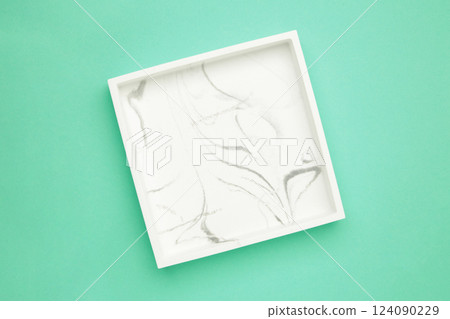Ceramic square tray on a mint background Ceramic square tray on a mint background 124090229