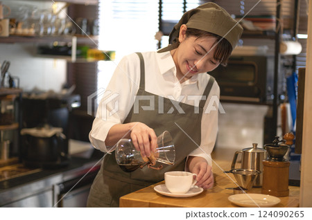 Cafe clerk serving coffee Cafe clerk serving coffee 124090265