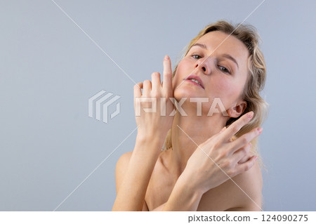 Elegant Pose of a Young Woman with Soft Expressions and Delicate Hand Gestures on a Neutral Background Elegant Pose of a Young Woman with Soft Expressions and Delicate Hand Gestures on a Neutral Background 124090275