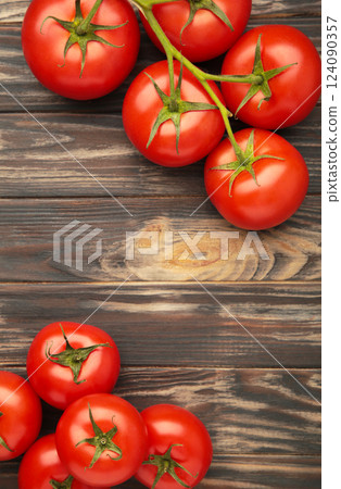Bunch of fresh tomatoes on brown background. Harvesting tomatoes. Space for text Bunch of fresh tomatoes on brown background. Harvesting tomatoes. Space for text 124090357