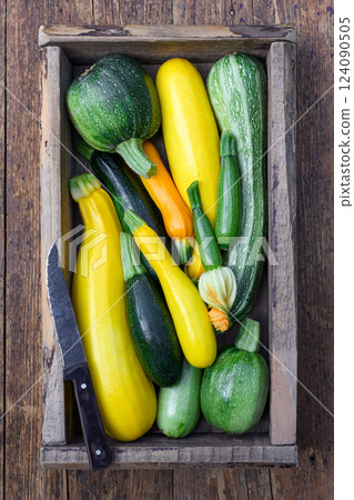 Top view on wooden box filled with fresh different kind zucchini Top view on wooden box filled with fresh different kind zucchini 124090505