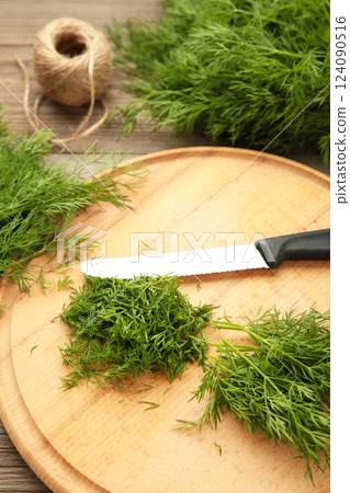 Cut dill on cutting board on grey background. Vertical photo 124090516
