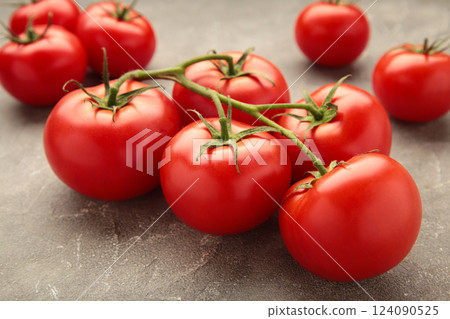 Bunch of fresh tomatoes on grey background. Harvesting tomatoes. Bunch of fresh tomatoes on grey background. Harvesting tomatoes. 124090525