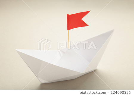 White paper ships and red flags on grey background. 124090535