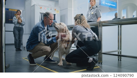 Mature Man with Pet During Screening Procedure in Airport Terminal: Female TSA Officer Examining Dog Mature Man with Pet During Screening Procedure in Airport Terminal: Female TSA Officer Examining Dog 124090790