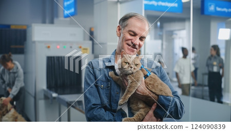 Airport Terminal: Portrait of Mature Man Holding Cat in Hands, Smiling and Looking at Camera 124090839