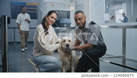 Airport Terminal: Portrait of Woman and TSA Officer Sitting with Dog, Smiling and Looking at Camera 124090875