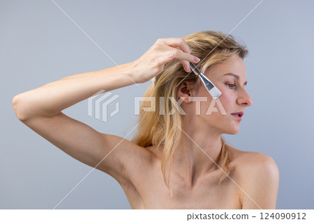 A Close-Up Shot of a Woman Applying Skincare with a Brush, Showcasing the Beauty Rituals and the Importance of Self-Care in Skincare Routines A Close-Up Shot of a Woman Applying Skincare with a Brush, Showcasing the Beauty Rituals and the Importance of Self-Care in Skincare Routines 124090912