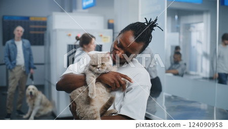 Airport Terminal: Portrait of Happy Man Holding His Cat, Smiling and Looking at Camera Airport Terminal: Portrait of Happy Man Holding His Cat, Smiling and Looking at Camera 124090958