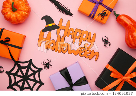 Inscription Happy Halloween with gift boxes, spiders on pink background. 124091037