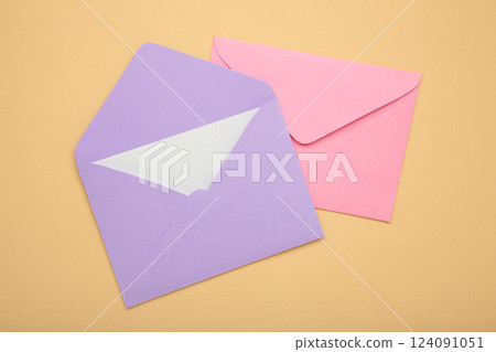 Mockup with pink and purple envelopes on beige background. 124091051