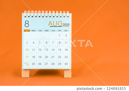 August 2025 desk calendar stand on orange textile background. 124091815