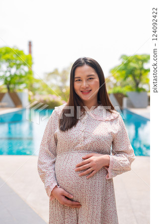 Pregnant woman portrait next to swimming pool 124092422