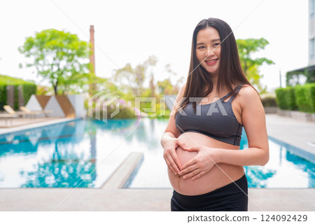 Pregnant fitness woman at swimming pool Pregnant fitness woman at swimming pool 124092429