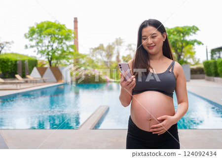 Pregnant fitness woman at swimming pool Pregnant fitness woman at swimming pool 124092434