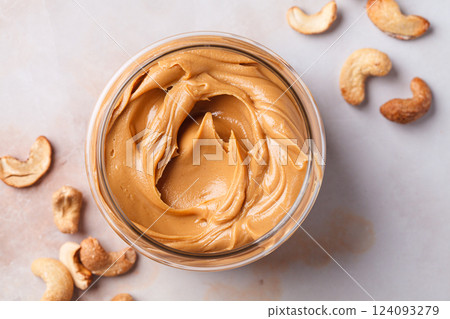 Cashew homemade nut butter in glass jar. Vegan snack concept. 124093279