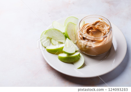Cashew homemade nut butter with green apple. Vegan snack concept. Cashew homemade nut butter with green apple. Vegan snack concept. 124093283