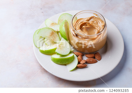 Almond homemade nut butter with green apple. Vegan snack concept. 124093285
