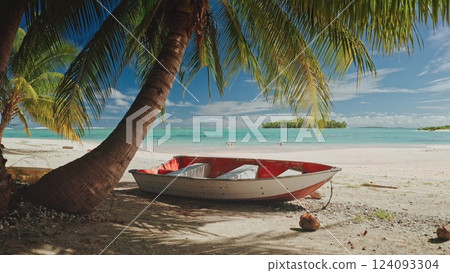 Tranquil beach, old wooden boat on soft sand, lush palm coconut trees. The clear turquoise water sparkles under a bright sky, creating a peaceful atmosphere. Remote wild nature paradise, exotic travel 124093304
