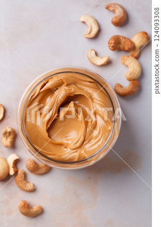 Cashew homemade nut butter in glass jar. Vegan snack concept. 124093308