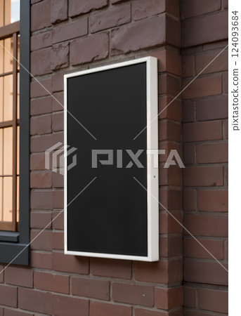 Blank black glass rectangular poster mock up brick wall mounted. 124093684