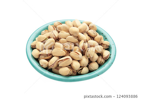 Salted pistachios for beer isolated on white background. Healthy delicious pistachios in plate. 124093886
