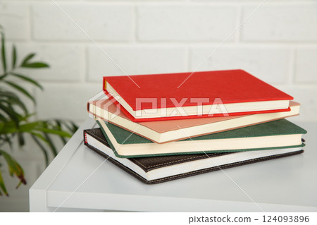 Table with notebooks on a light background. Table with notebooks on a light background. 124093896