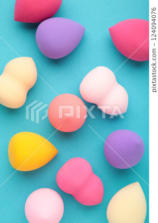 Beauty blender. Cosmetic sponge on blue background. Beauty concept. Vertical photo 124094076