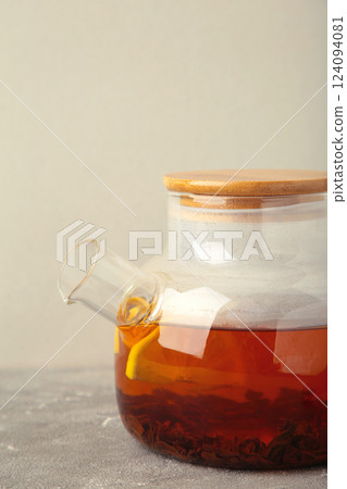 Black tea with lemon on grey background. Vertical photo 124094081
